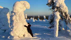 Hugging snowy trees in Riisitunturi Posio Lapland